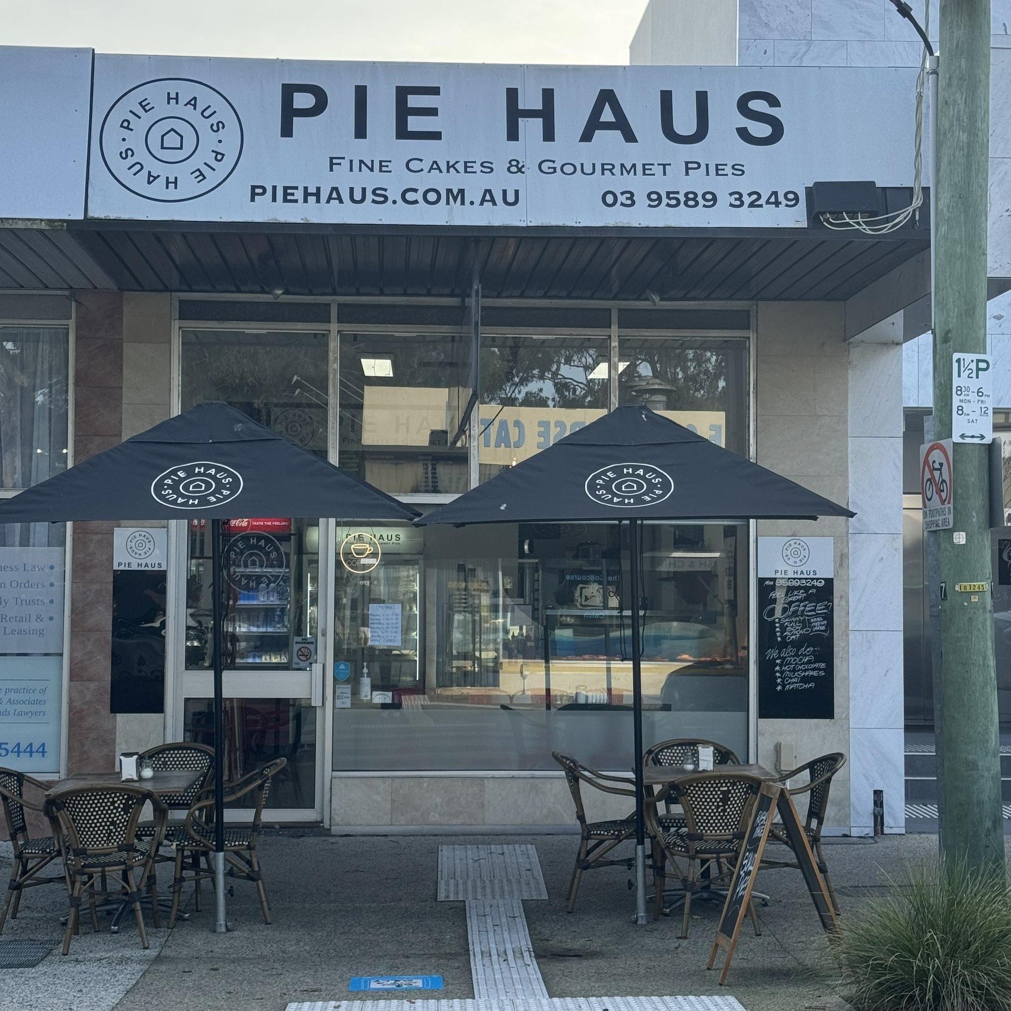 The Pie Haus shopfront on North Concourse, with black umbrellas and tables out the front